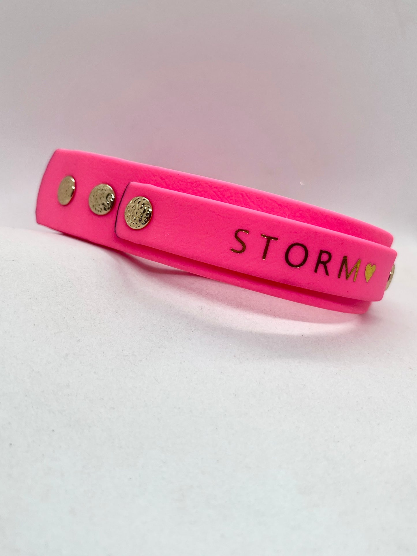 A bright neon pink dog collar with gold metal rivets, personalised name on handle JOOLS LONDON